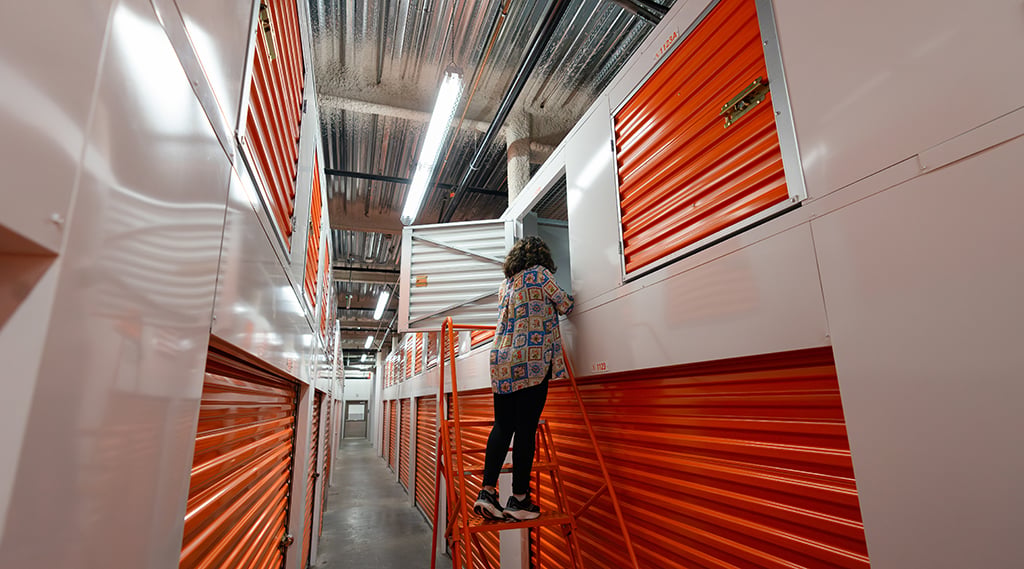 young woman moving items into storage lockers